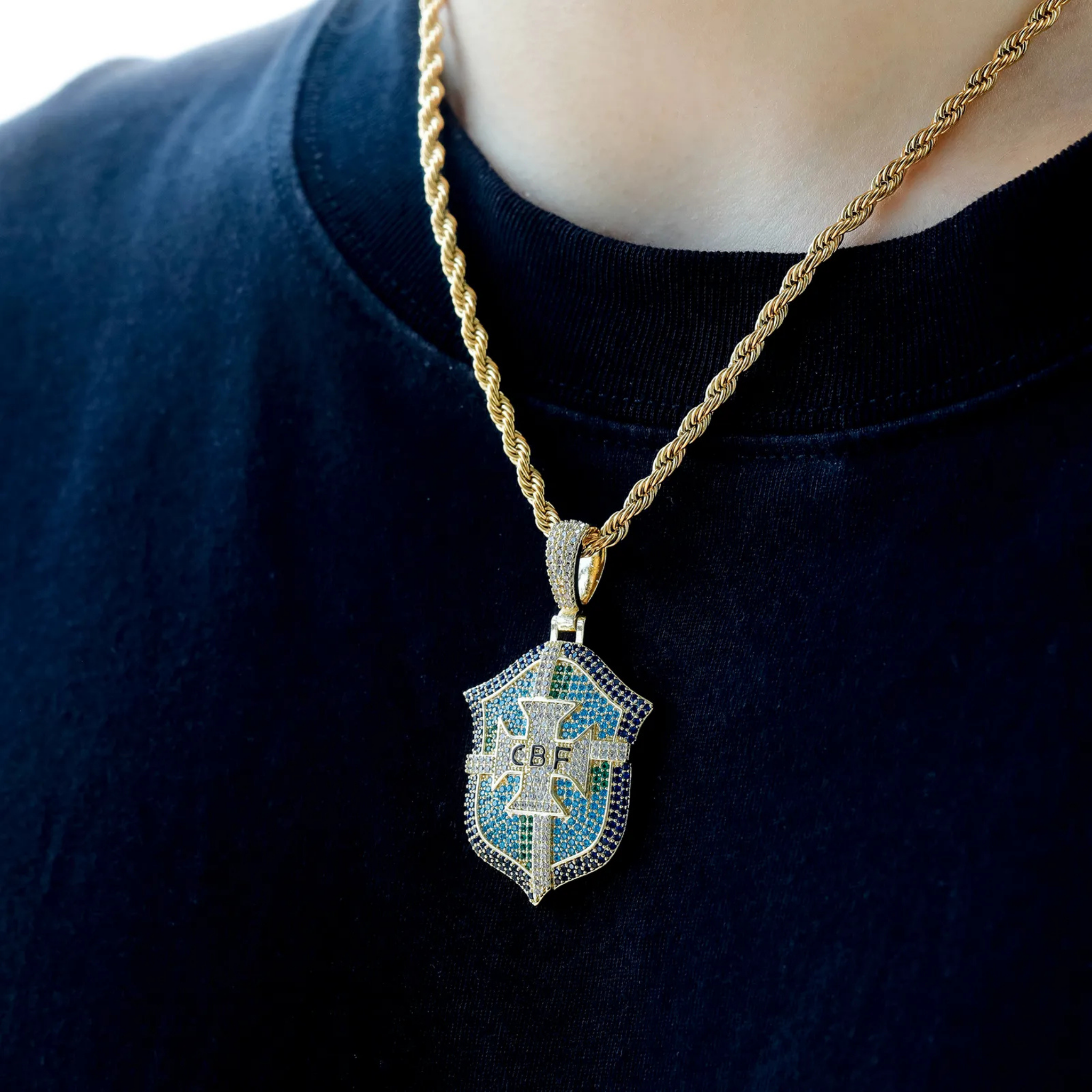 Gold Brazilia iced pendant worn with the included 24-inch twist chain
